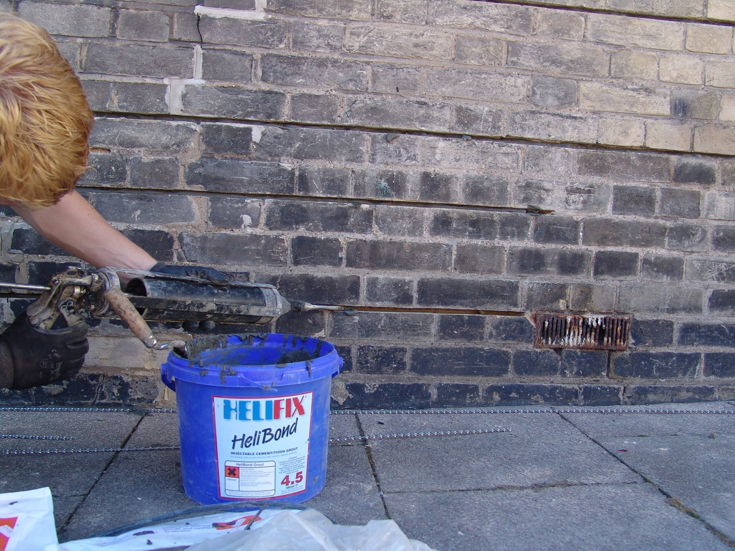Masonry Reinforcement | Construction worker using Helifix on a tile wall.