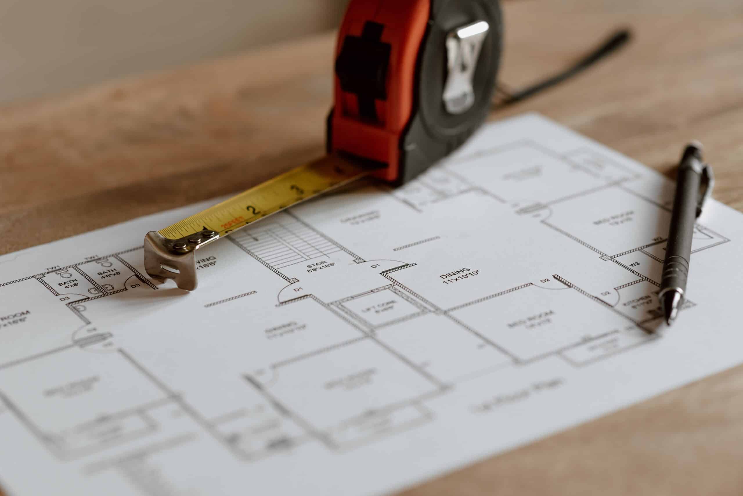 Basement Construction | A construction meter on top of a building plan.
