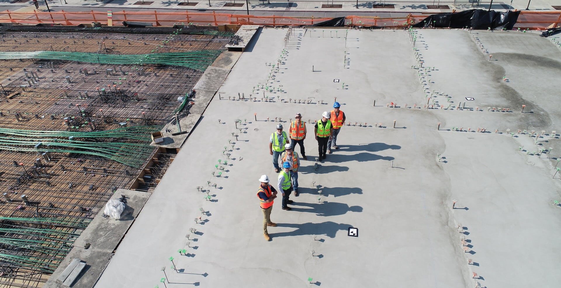 Multiple conctruction workers walking on a construction site.