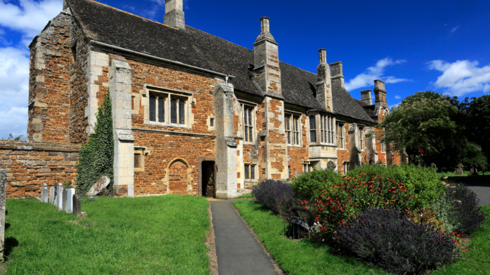 English Heritage Approved Stone and Masonry Cleaning Techniques | An old English house with a lot of greenery space.